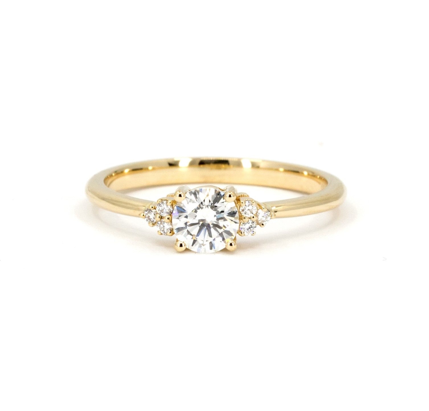 Round Diamond Desir Ring in yellow gold featuring a round-cut diamond and side accents by Bena Jewelry photographed on a clean white background custom-made in Montreal