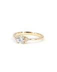 Classic yellow gold engagement ring with a central round diamond and sparkling side stones by Bena Jewelry displayed on a white background bridal jewelry made in Canada