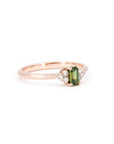 Rose gold engagement ring with a baguette-cut green sapphire and round diamonds Désir Ring by Bena Jewelry displayed on a white background fine bridal jewelry in Canada