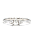 Désir Ring with a pear-shaped diamond and side diamonds, set in white gold. Handmade by Bena Jewelry in Montreal.