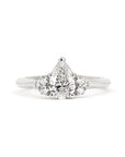 White gold engagement ring with a central pear-shaped diamond and side diamonds, custom-made by Bena Jewelry in Montreal, Canada.
