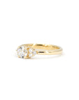 Montreal-made yellow gold engagement ring with a round diamond and sparkling side stones, styled on a white background by Bena Jewelry.