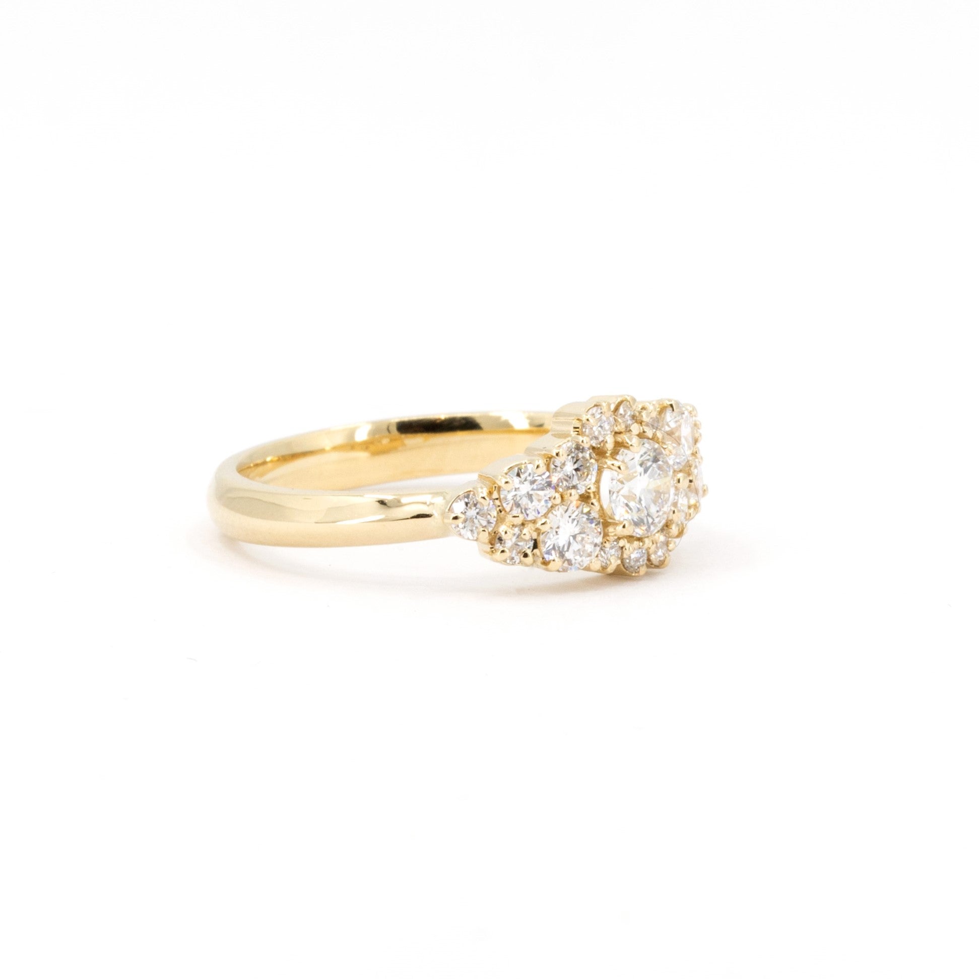 Side view of a handcrafted yellow gold ring featuring 17 lab-grown round brilliant diamonds. This bold and modern statement piece is available through Bena Jewelry in Montreal, Canada.