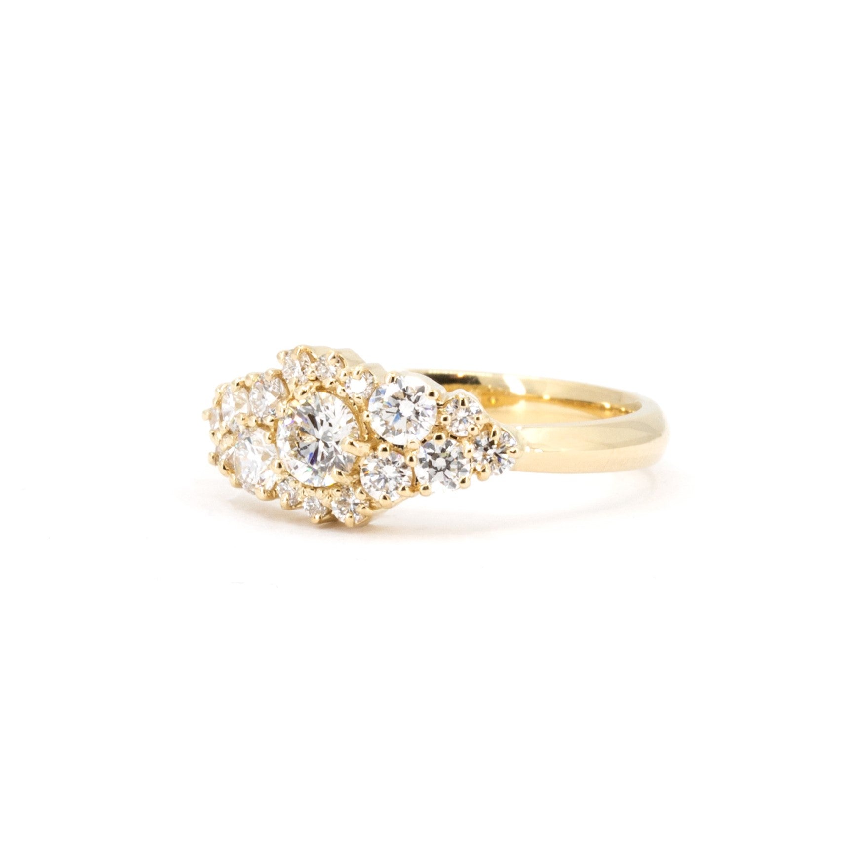 Opposite side view of a handcrafted yellow gold ring set with 17 lab-grown round brilliant diamonds. A striking and contemporary design available through Bena Jewelry in Montreal, Canada.