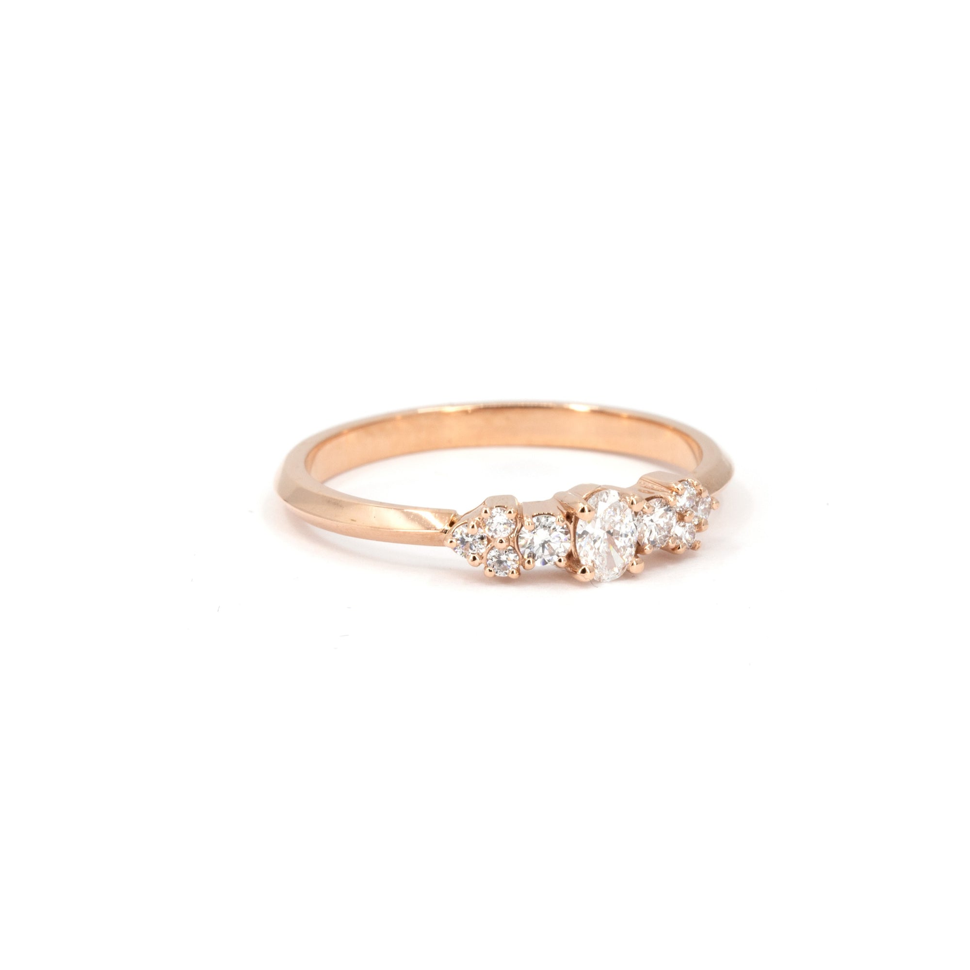 Lile engagement ring in rose gold with oval and round lab diamonds, created by Canadian designer Bena Jewelry in Montreal – modern fine jewelry on white background.