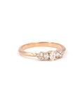 Lile engagement ring in rose gold with oval and round lab diamonds, created by Canadian designer Bena Jewelry in Montreal – modern fine jewelry on white background.