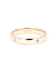 Gold wedding band with bezel-set diamonds, handmade in Montreal by Bena Jewelry, a timeless men’s wedding ring.