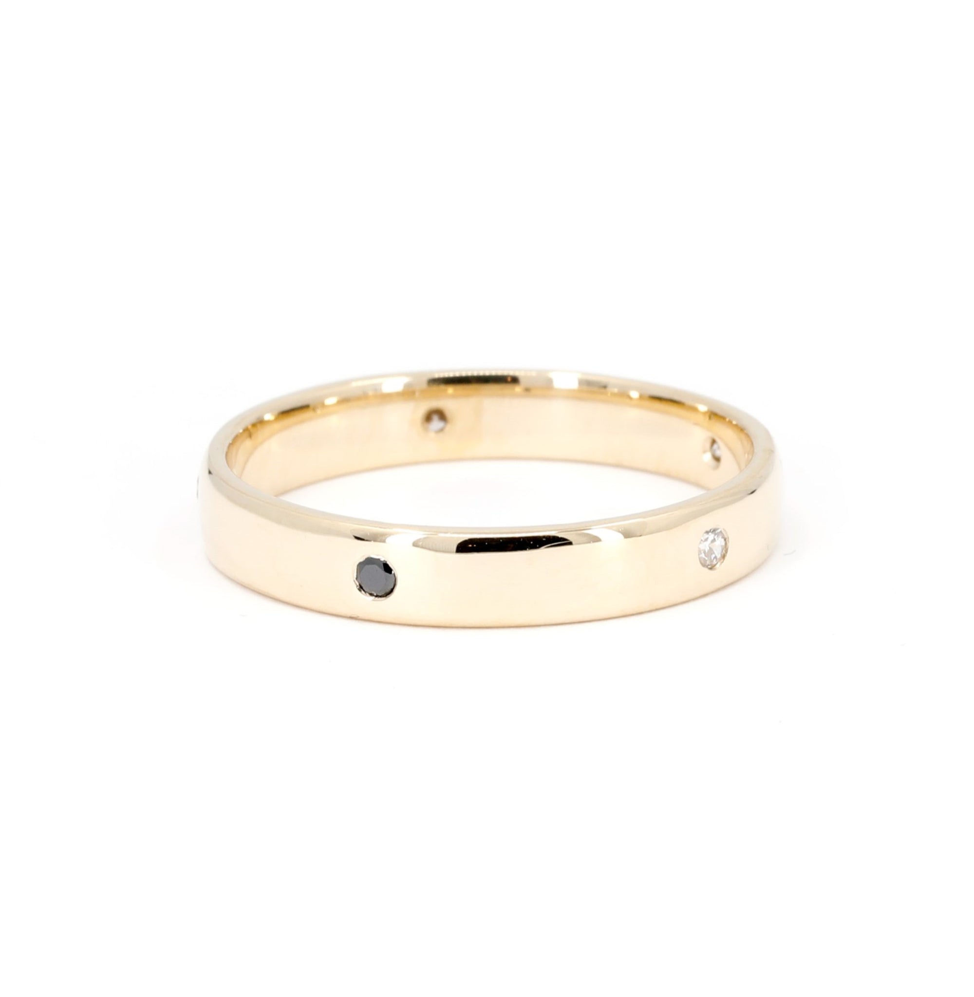 Minimalist yellow gold wedding band with round-cut diamonds, crafted by Bena Jewelry in Canada for a modern groom.