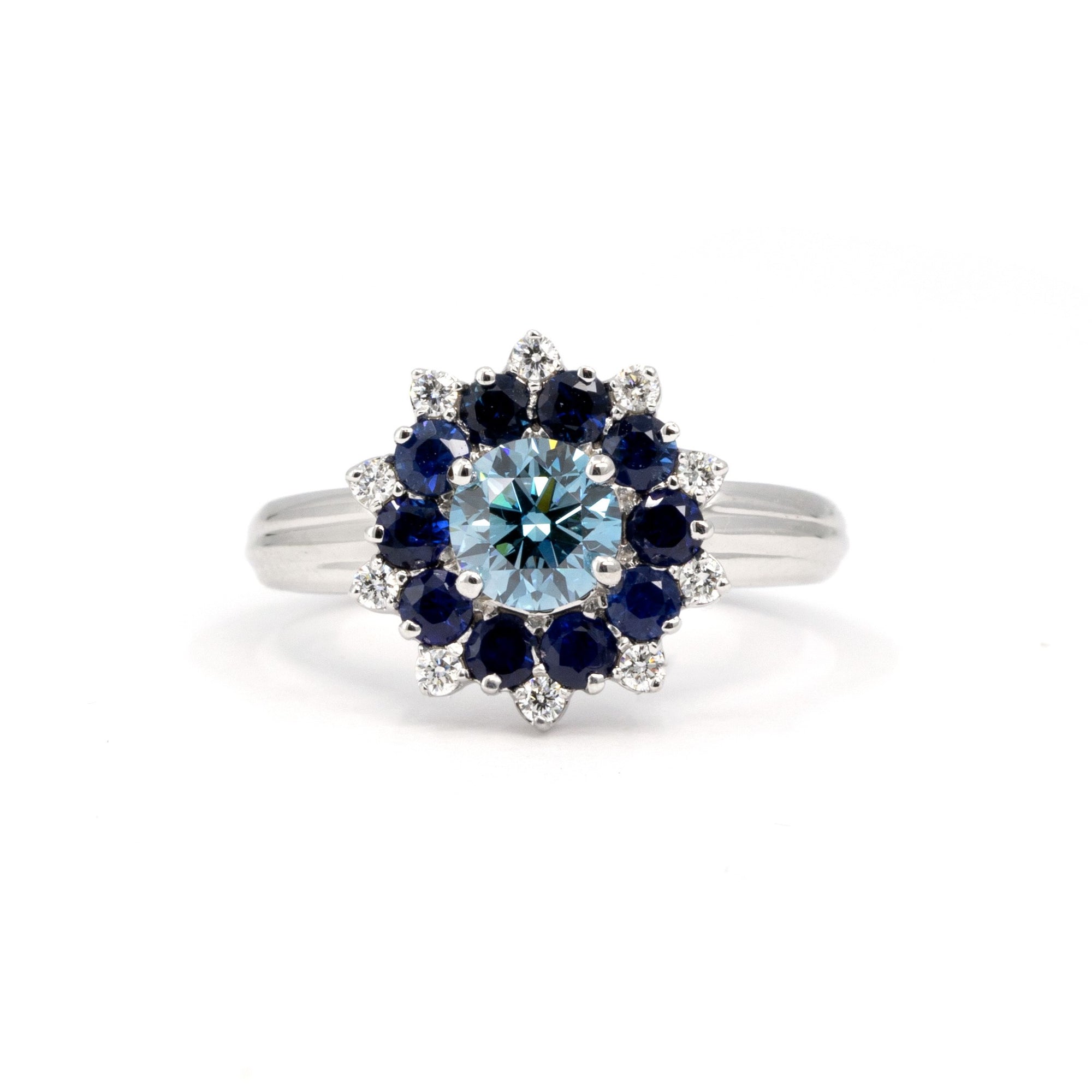 Soleil Ring by Bena Jewelry, white gold ring with lab-grown blue diamond, sapphire and diamond halo, elegant and bold design.