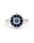 Soleil Ring by Bena Jewelry, white gold ring with lab-grown blue diamond, sapphire and diamond halo, elegant and bold design.