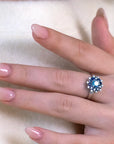 Close-up of the Soleil Ring worn, highlighting its intricate sapphire and diamond halo design, handcrafted in Montreal.