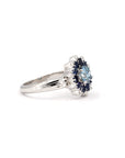 Soleil Ring close-up, showcasing custom-set blue diamond and sapphire halo in white gold, handcrafted in Montreal by Bena Jewelry.