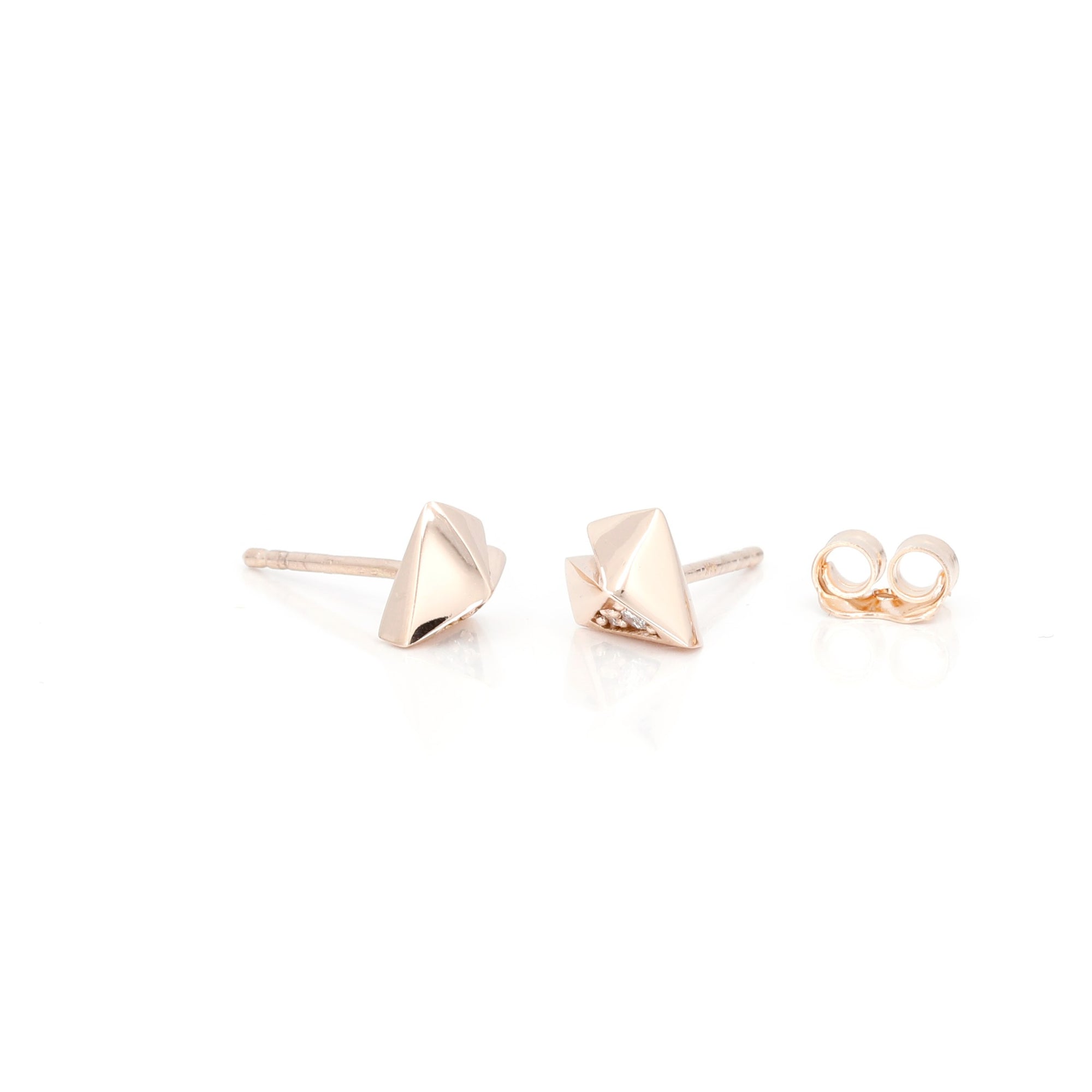 Geometric heart-shaped earrings in rose gold with diamonds crafted by Bena Jewelry photographed on a white background edgy fine jewelry