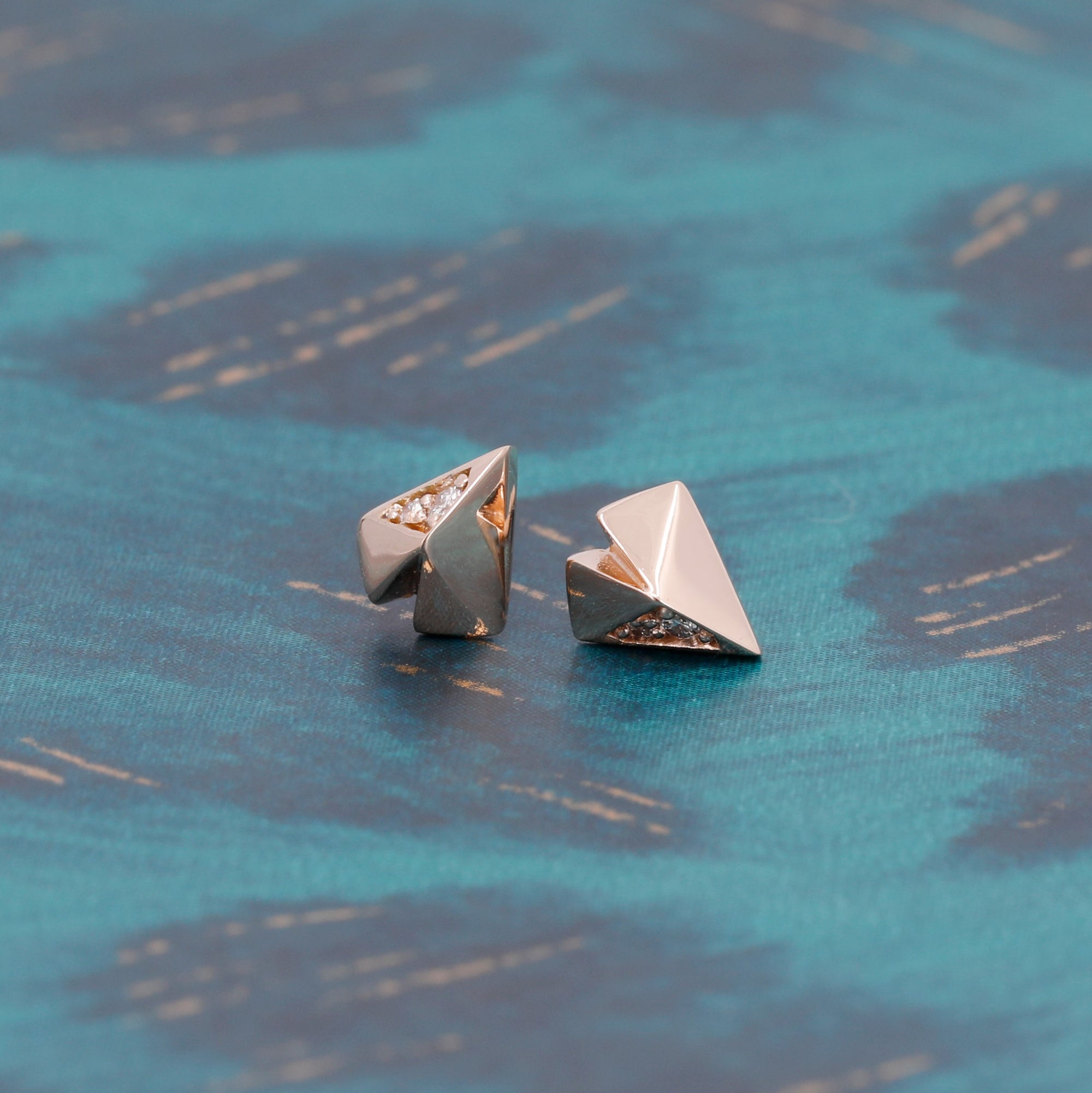 Edgy Diamond Heart Studs in rose gold featuring diamonds by Bena Jewelry photographed on a dark background modern fine jewelry custom-crafted in Montreal