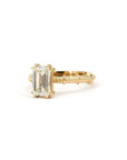 Custom emerald-cut diamond ring in yellow gold, featuring a textured band handcrafted in Montreal, Canada.