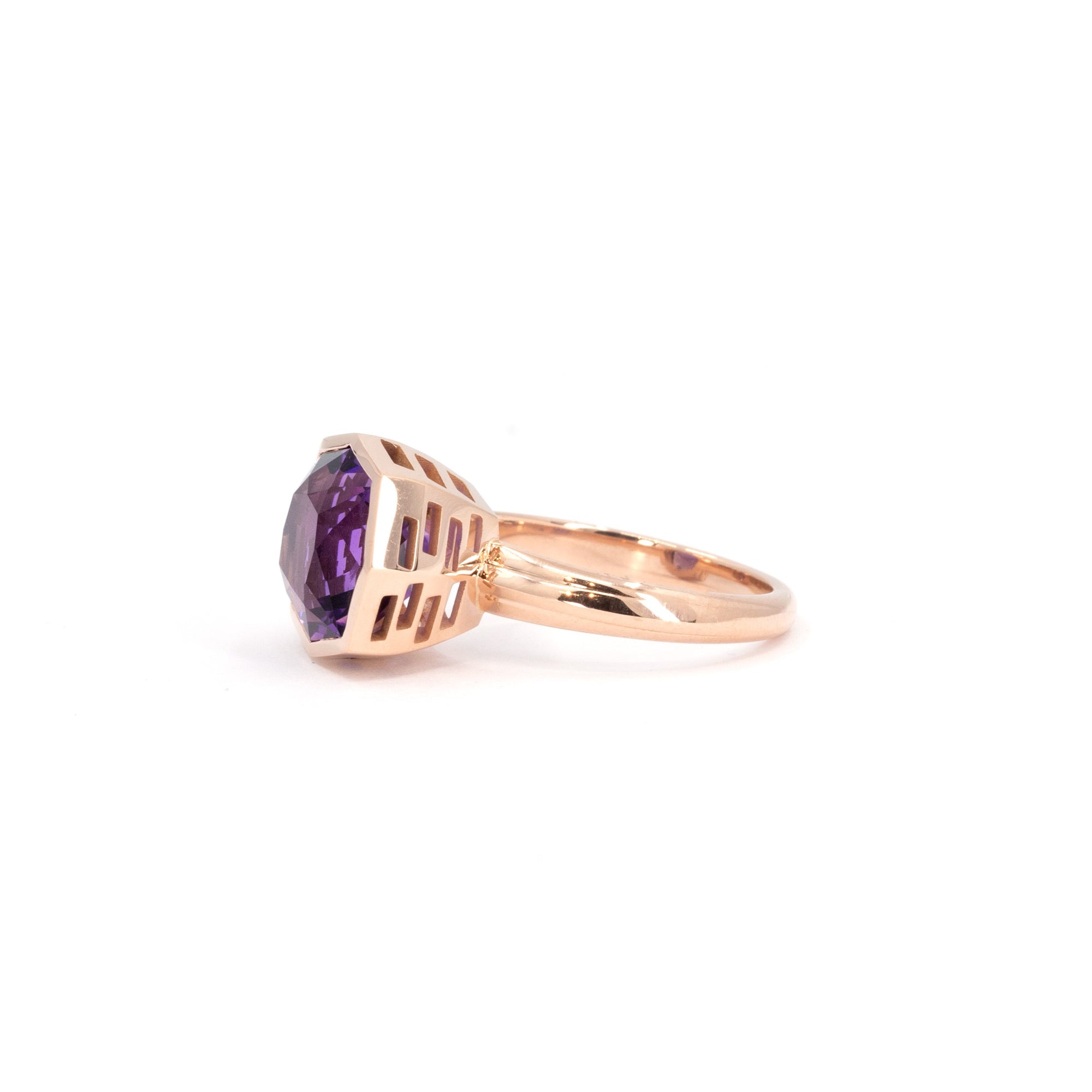 Side view of statement Brazilian amethyst ring with subtle pink undertones, robust rose gold band, displayed on a white surface.