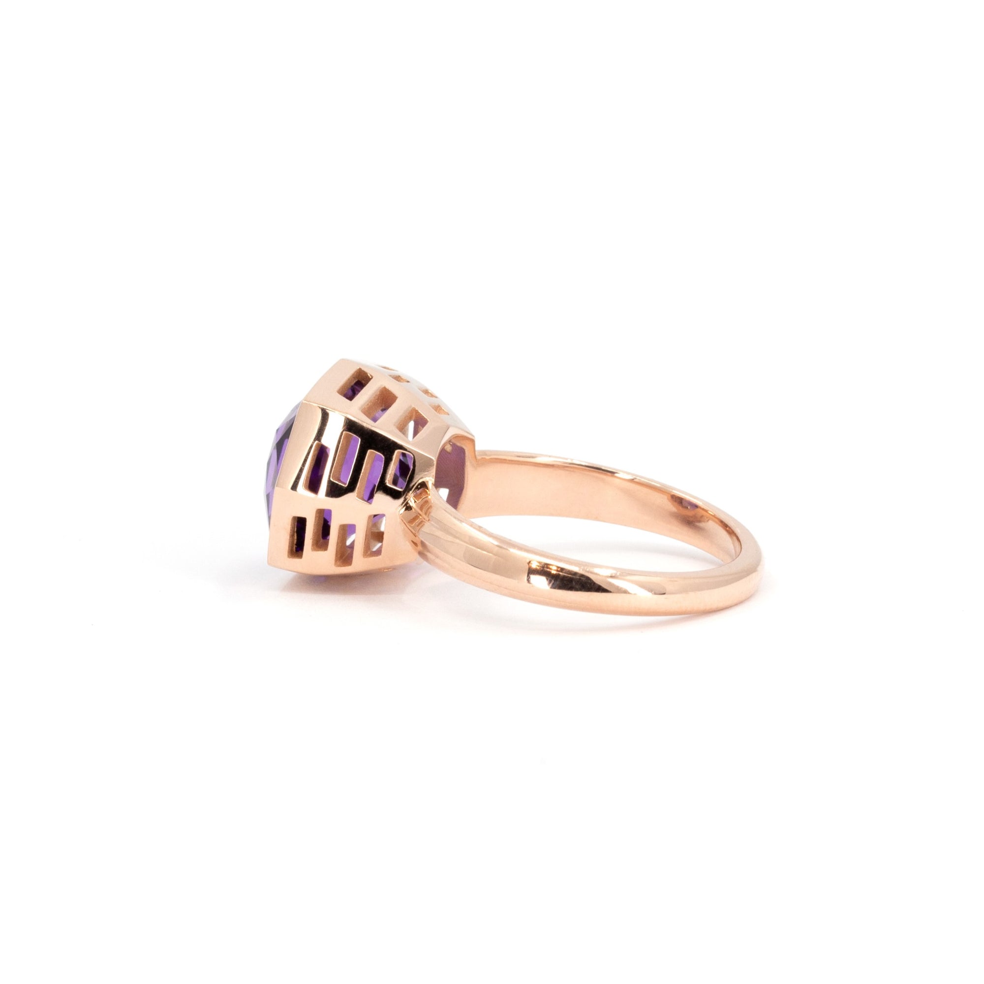 Rich purple amethyst ring in rose gold, with an edgy octagonal cut, glowing against a white background.