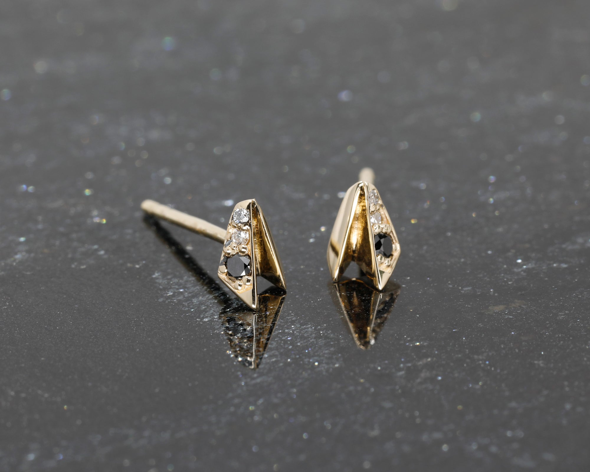 Close-up of Edges Diamond Studs, showcasing sleek yellow gold and bold diamond accents by Bena Jewelry.