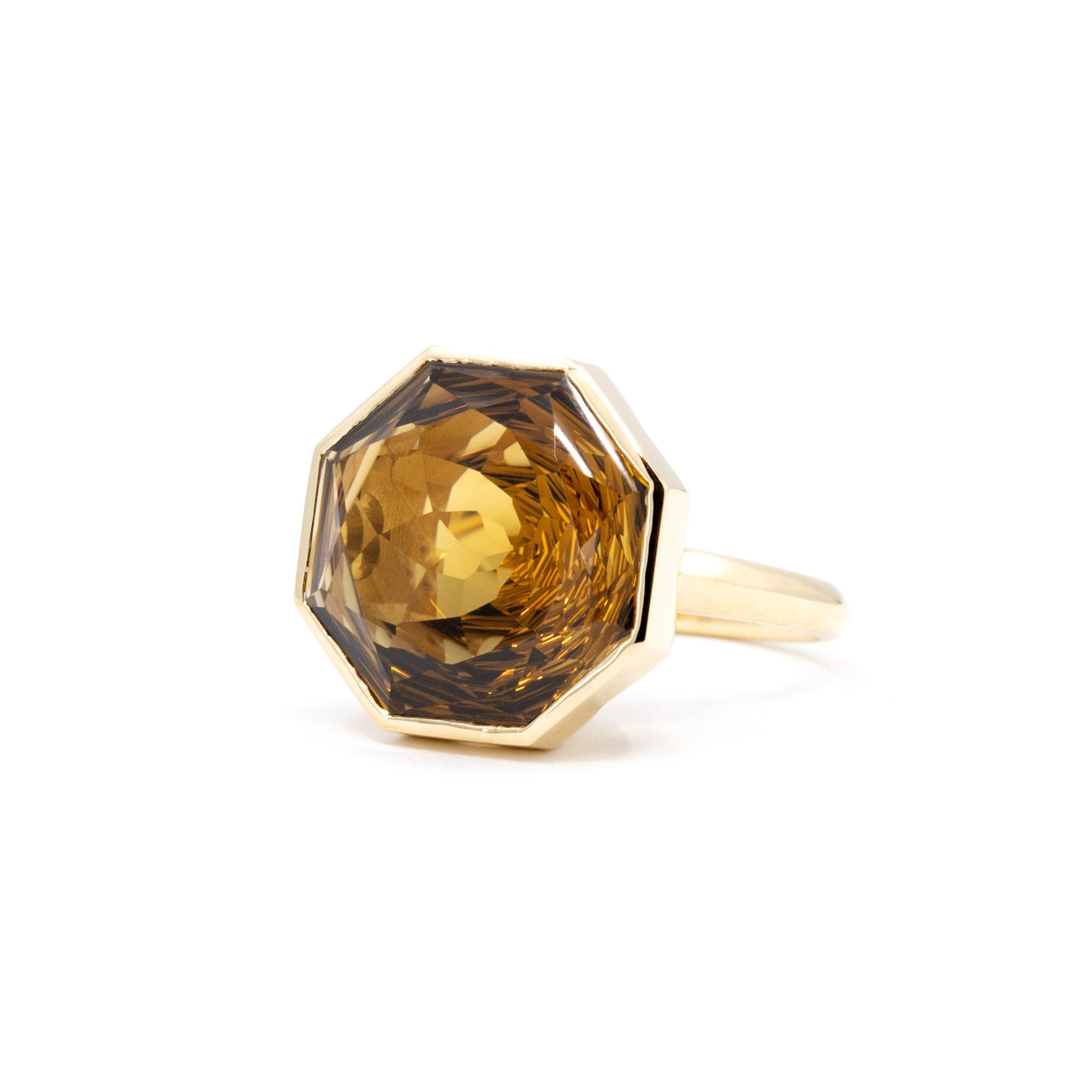 Statement cocktail ring featuring a large dark citrine in yellow gold, from the Fancy Edgy collection by Bena Jewelry, photographed on a white surface.