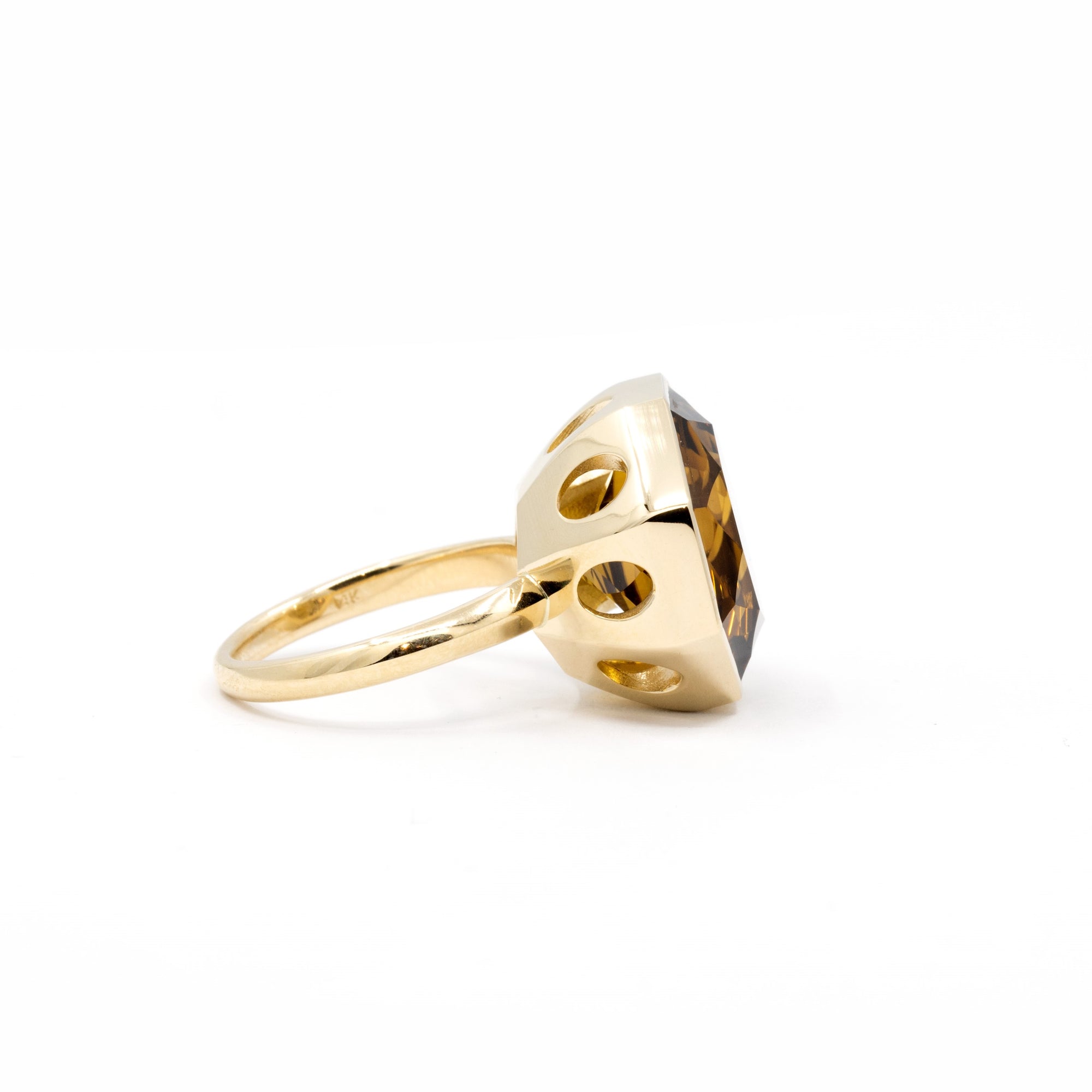 Side view of a bold dark citrine ring with an octagonal cut, designed by Bena Jewelry, photographed on a minimalist white surface.
