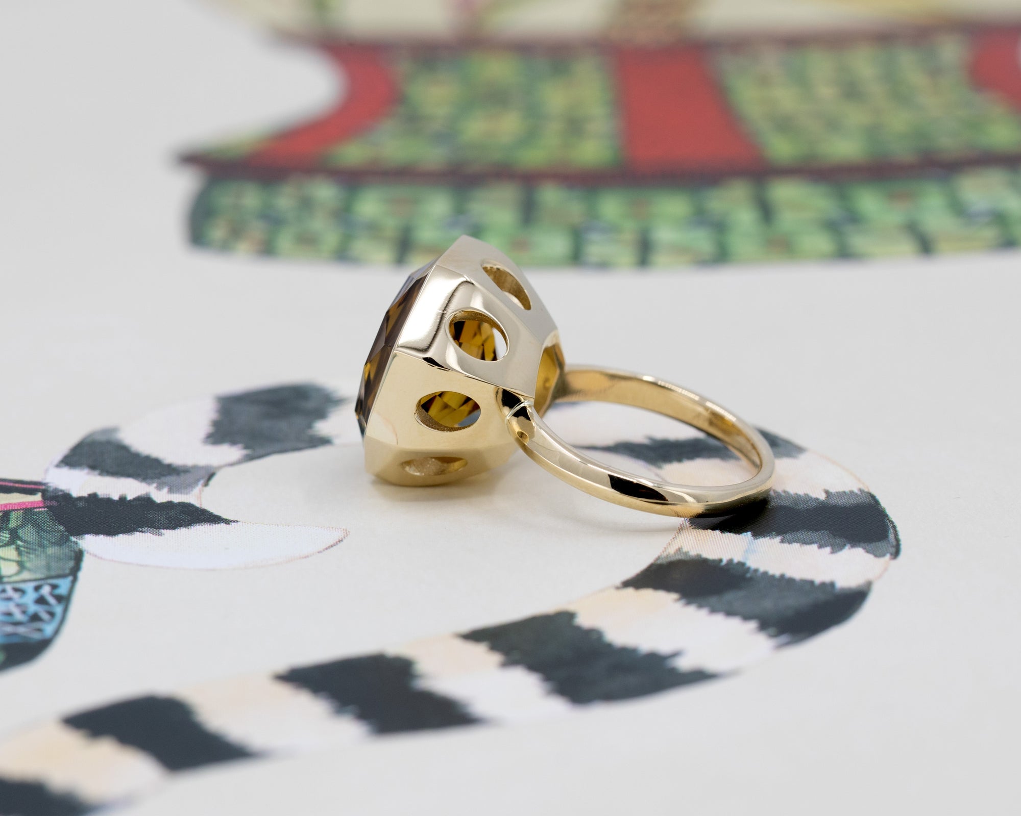 Bijou Octagonal Dark Citrine Ring with a contemporary design, captured on a bold and colorful surface.