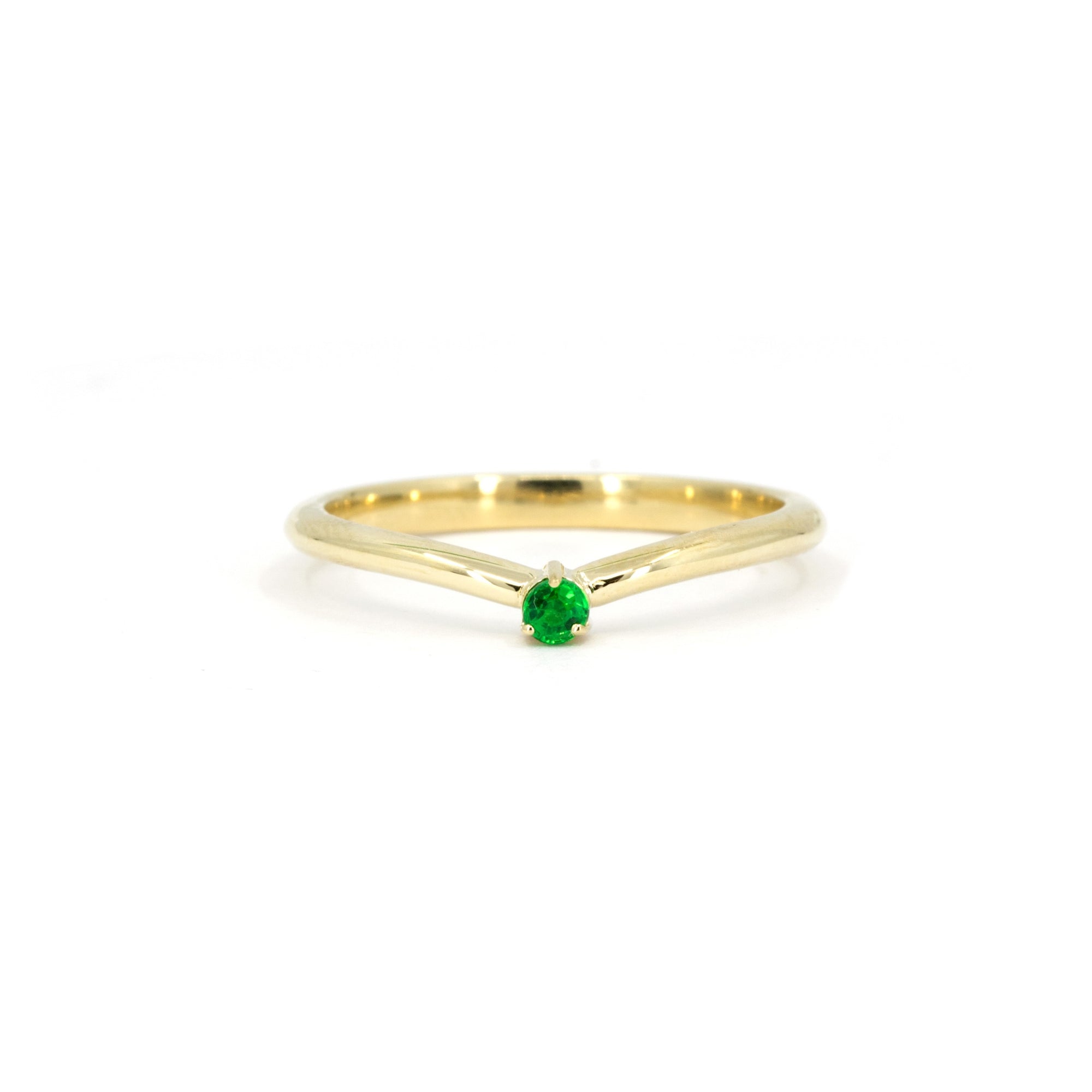 Minimalist yellow gold ring with a vibrant green Tsavorite gemstone in a delicate prong setting, designed by Bena Jewelry.