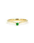 Minimalist yellow gold ring with a vibrant green Tsavorite gemstone in a delicate prong setting, designed by Bena Jewelry.