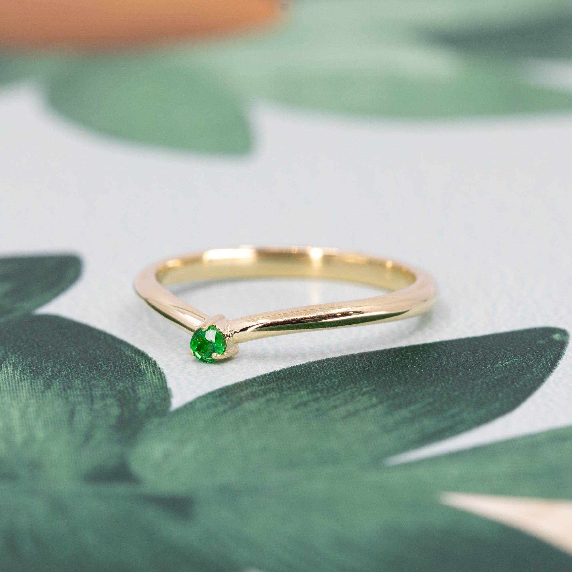 Elegant yellow gold band featuring a striking Tsavorite gemstone, perfect for bold, luxury jewelry lovers. A sophisticated design by Bena Jewelry.