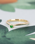 Elegant yellow gold band featuring a striking Tsavorite gemstone, perfect for bold, luxury jewelry lovers. A sophisticated design by Bena Jewelry.