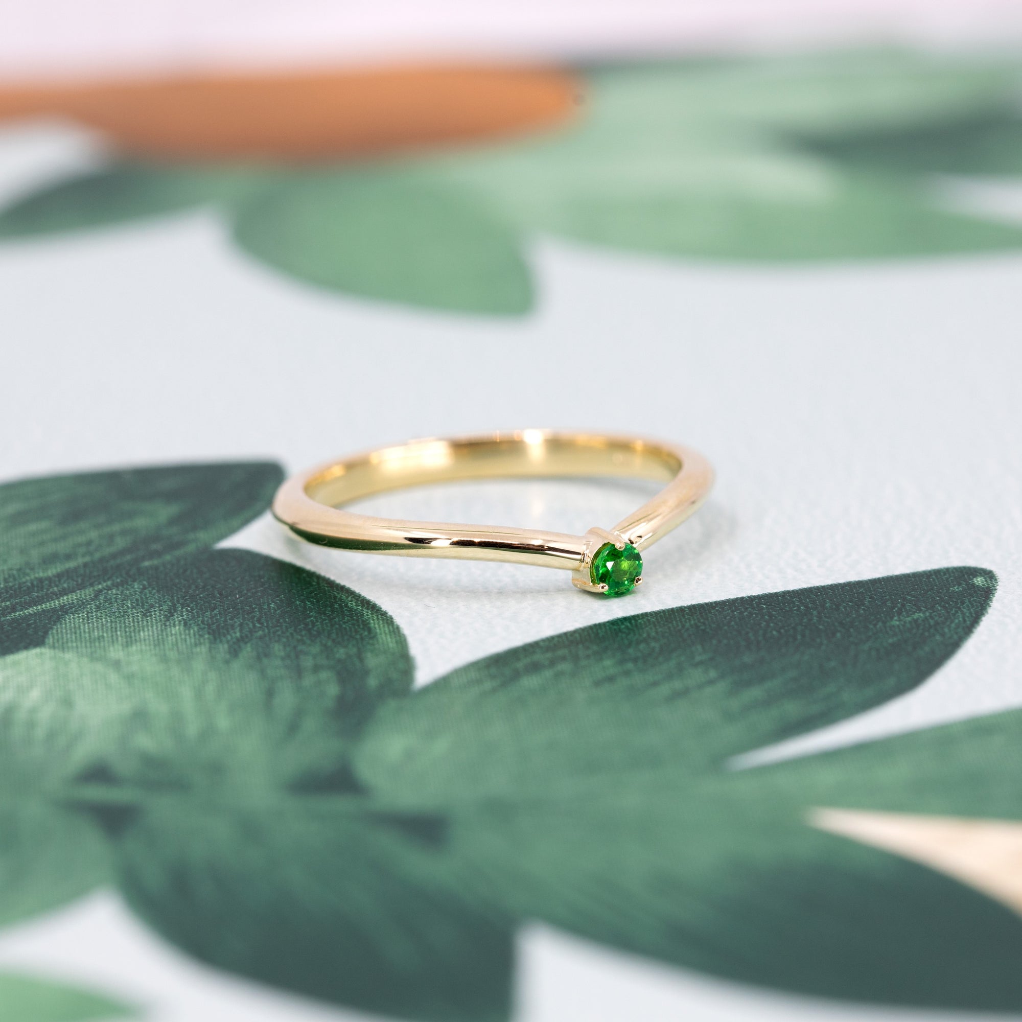 Elegant yellow gold band featuring a striking Tsavorite gemstone, perfect for bold, luxury jewelry lovers. A sophisticated design by Bena Jewelry.