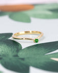 Elegant yellow gold band featuring a striking Tsavorite gemstone, perfect for bold, luxury jewelry lovers. A sophisticated design by Bena Jewelry.