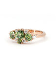 Rose gold ring with vibrant green sapphire and deep green garnets, a custom creation by Bena Jewelry in Montreal.