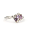 Close-up of Bena Jewelry's Kink Avalanche white gold ring, highlighting the vivid purple and pink sapphires in various cuts and sparkling diamonds, set against a white background.