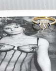 Marquise Diamond and Sapphire Engagement Ring in yellow gold by Bena Jewelry, photographed on a dark background, custom bridal jewelry crafted in Montreal.