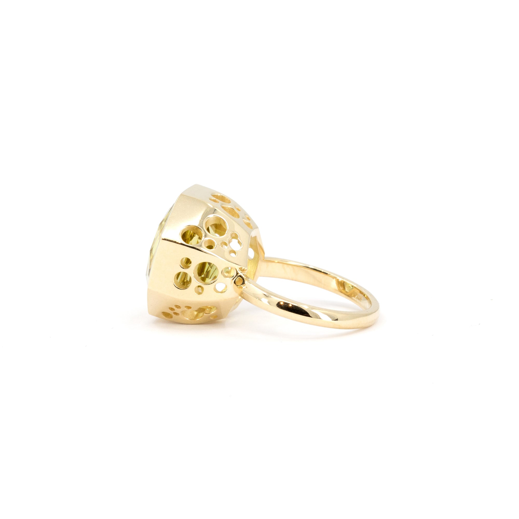 Statement yellow gemstone ring in yellow gold, designed by Bena Jewelry and photographed on a pristine white background.