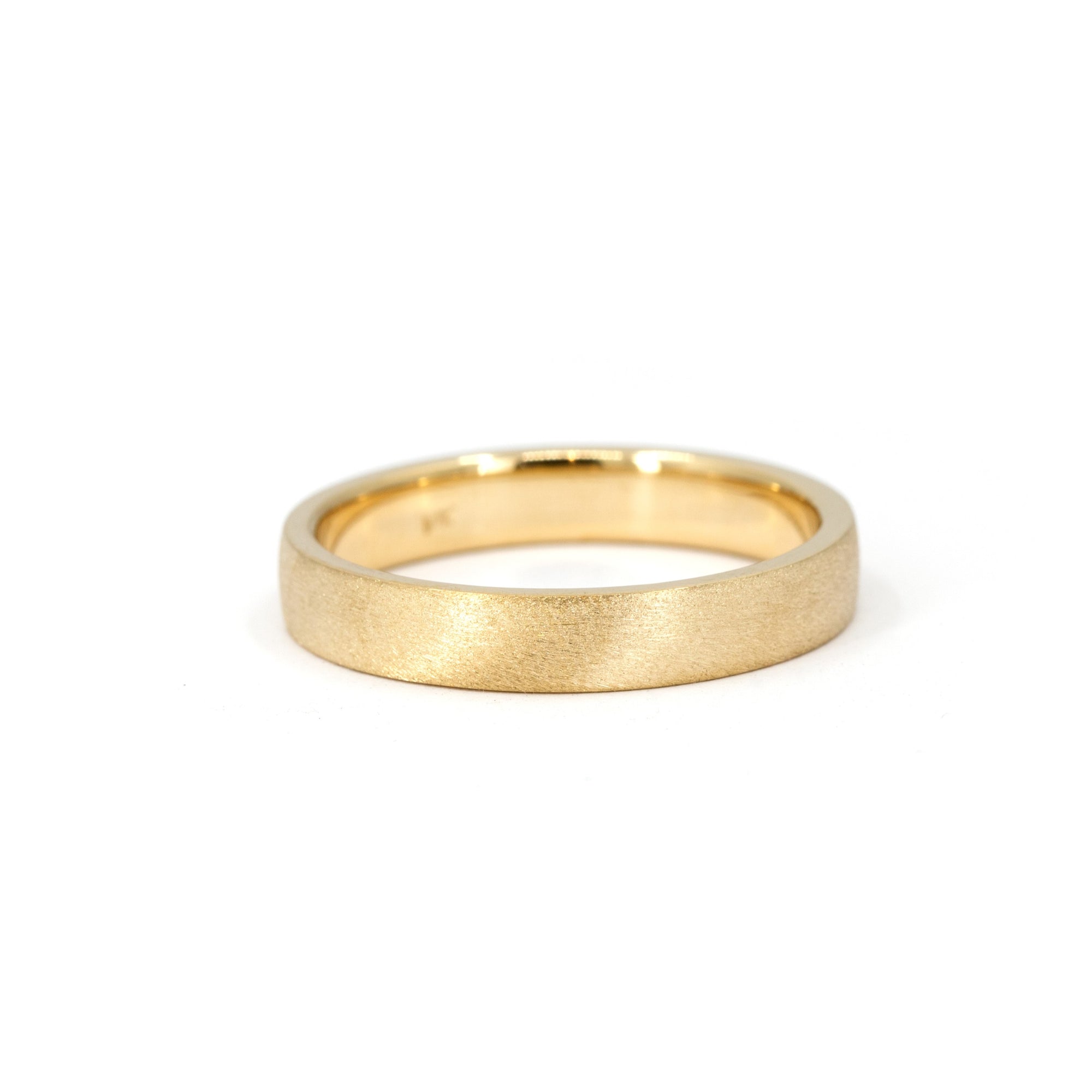 Close-up of the custom-made matte wedding ring, designed with a modern satin finish.