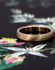 Side view of the yellow gold wedding band, showing its minimalist elegance and fine craftsmanship from Bena Jewelry, Canada.