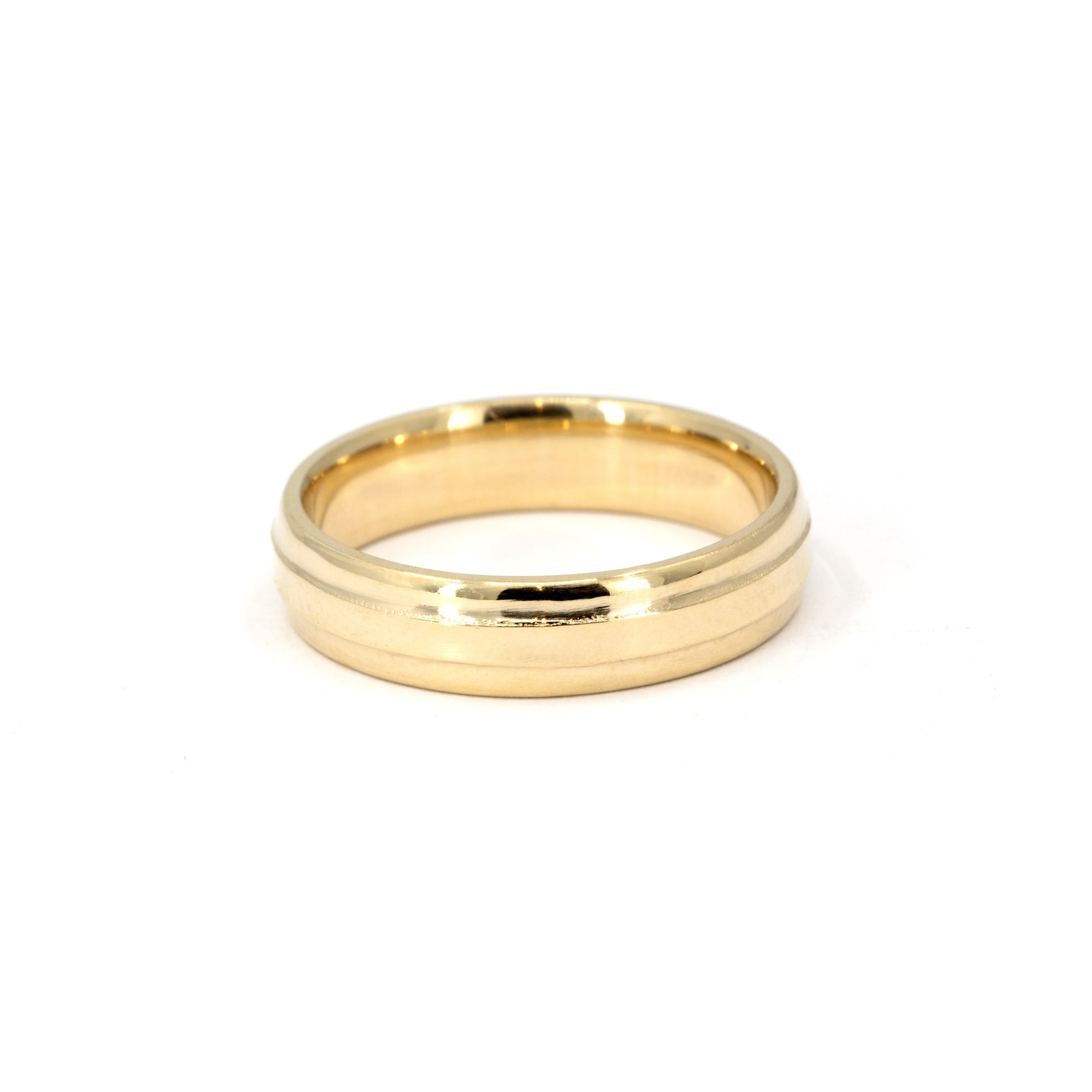 Minimalist gold band with a subtle center detail, worn daily – A custom-crafted wedding band by Bena Jewelry, blending classic and modern aesthetics.