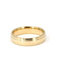 Minimalist gold band with a subtle center detail, worn daily – A custom-crafted wedding band by Bena Jewelry, blending classic and modern aesthetics.