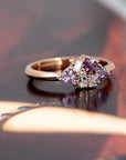 Side view of the Avalanche ring, showcasing the unique arrangement of pink and purple sapphires and diamonds in 14 kt rose gold.