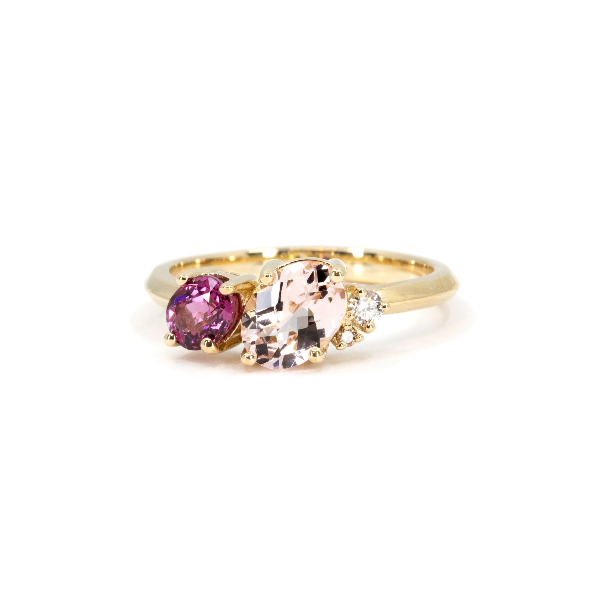 Close-up of Tracy ring showing pink morganite, purple rhodolite, and white diamond set on yellow gold.