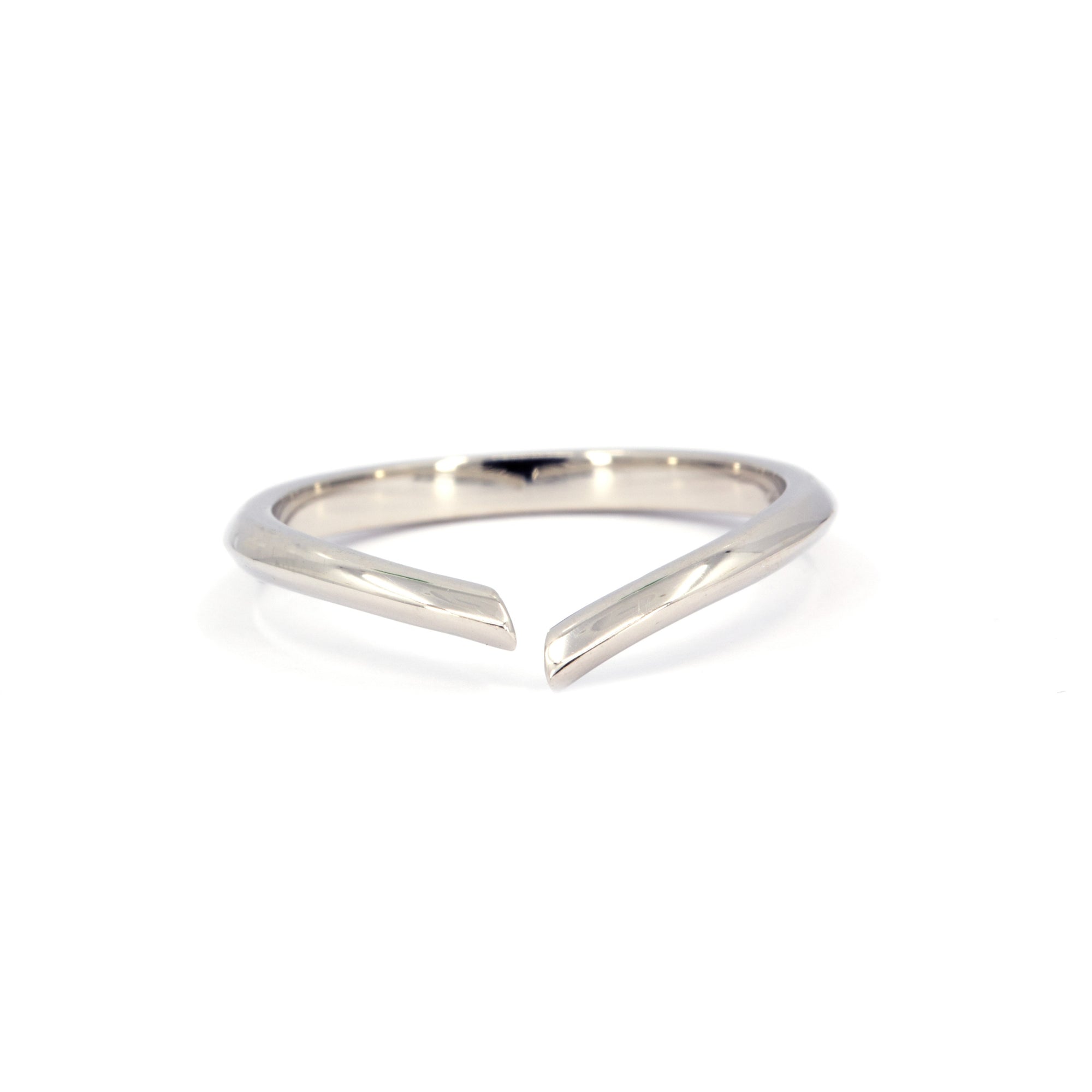 Minimalist open ring in white gold, designed by Bena Jewelry. Sleek and modern, this open-ended band has a polished finish and a contemporary edge. Handmade in Montreal, Canada.