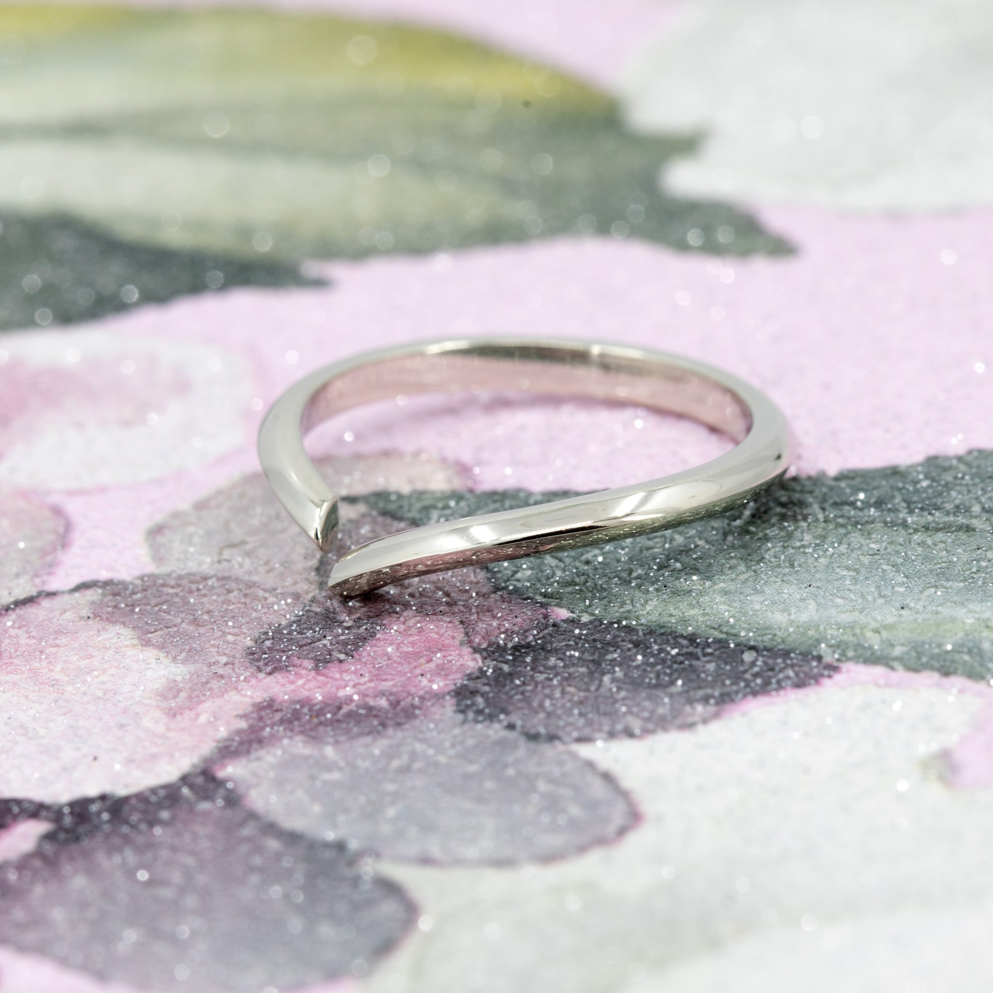 Sleek Gap Ring in white gold, displayed on a soft-colored background. The open design and polished finish highlight its modern, minimalist aesthetic. Handmade in Montreal by Bena Jewelry.