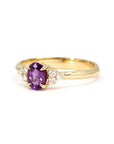 Close-up of the purple-pink sapphire Desir Ring in yellow gold, showcasing its elegant eagle-claw prong setting. Made in Canada by Bena Jewelry.