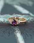 Artistic shot of the Desir Ring with a vibrant purple-pink sapphire and diamonds, set in yellow gold, crafted by Bena Jewelry in Montreal.