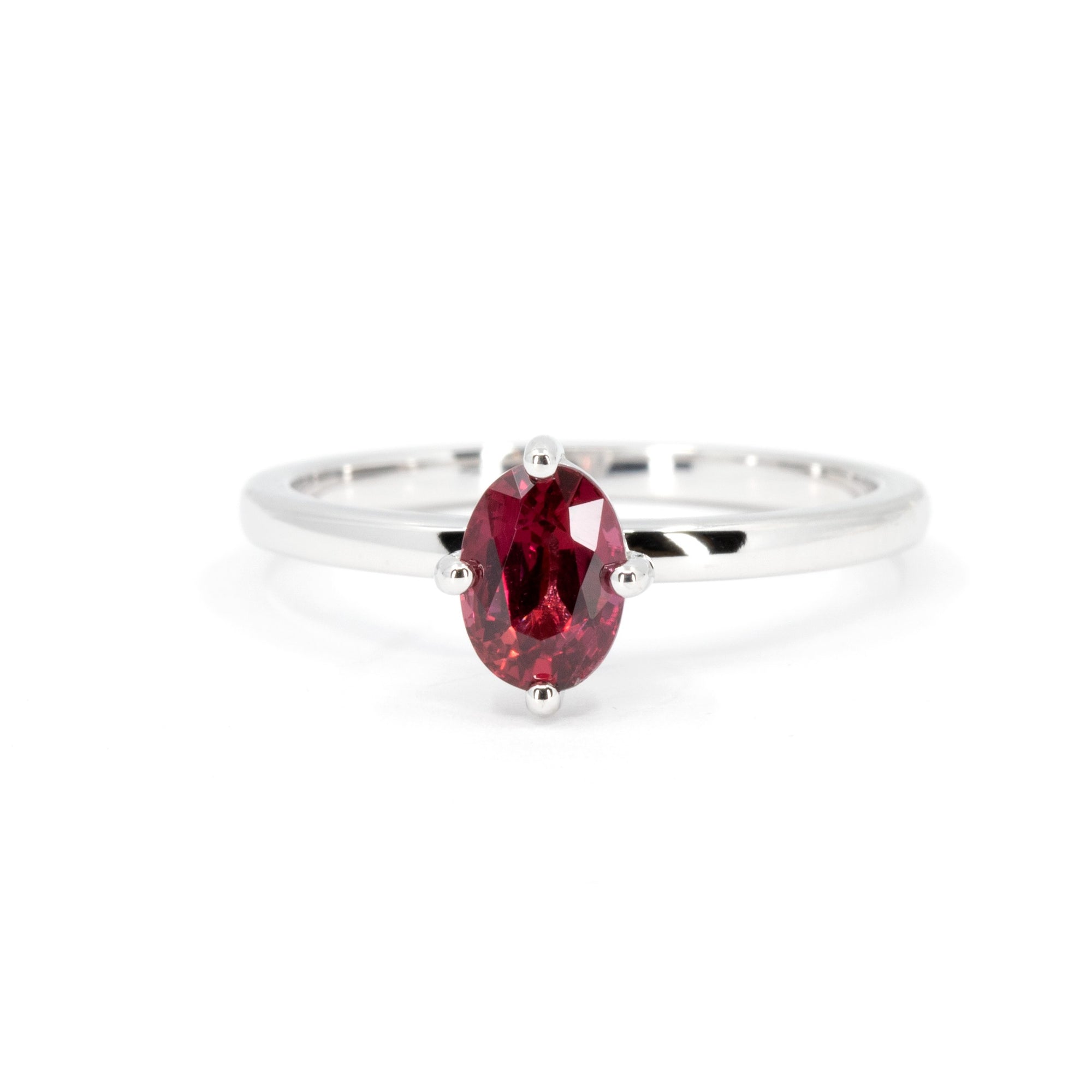 Solitaire ring with vivid oval ruby set in 14k white gold, handmade by Bena Jewelry in Montreal, Canada.