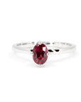 Solitaire ring with vivid oval ruby set in 14k white gold, handmade by Bena Jewelry in Montreal, Canada.