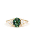 Teal Sapphire Oval Diamond Ring on white background – A bold engagement ring featuring an oval teal sapphire with green hues, accented by marquise and round diamonds in yellow gold. Handmade by Bena Jewelry in Montreal.