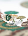 Close-up of teal sapphire ring – A vibrant teal sapphire with striking color depth, set with bezel-set diamonds for a modern, elegant look.