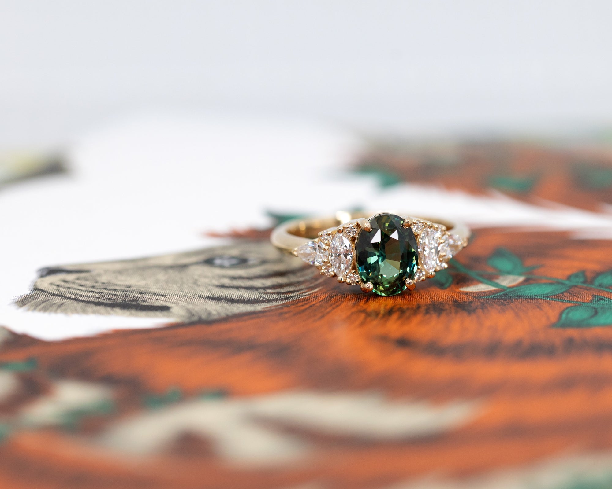 Top-down view of sapphire engagement ring – A handcrafted fine jewelry piece with a unique sapphire and a brilliant diamond arrangement.